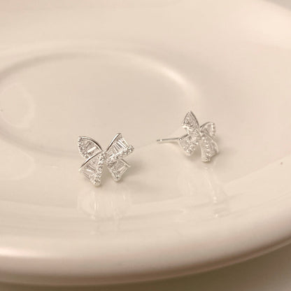 Silver bow earrings, hopea koru