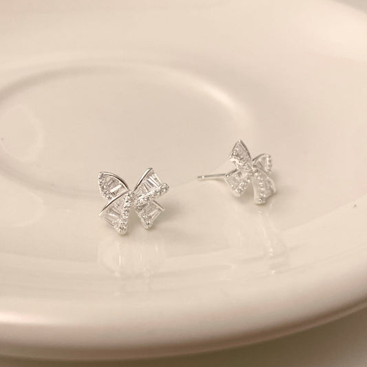 Silver bow earrings, hopea koru