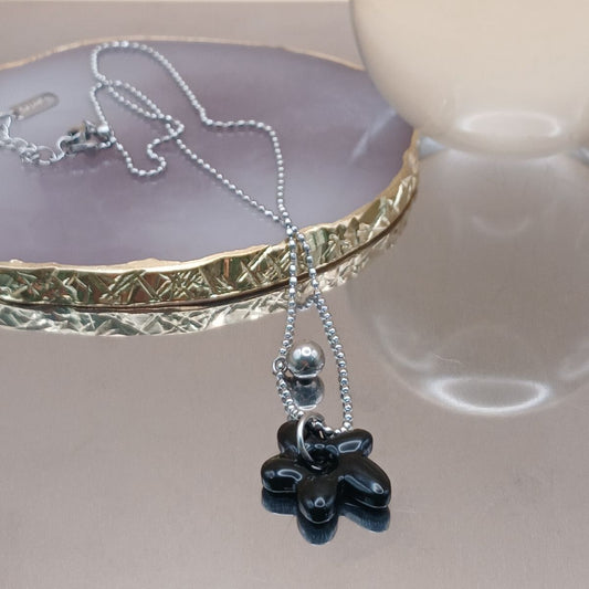 Necklace with a black flower pendant 